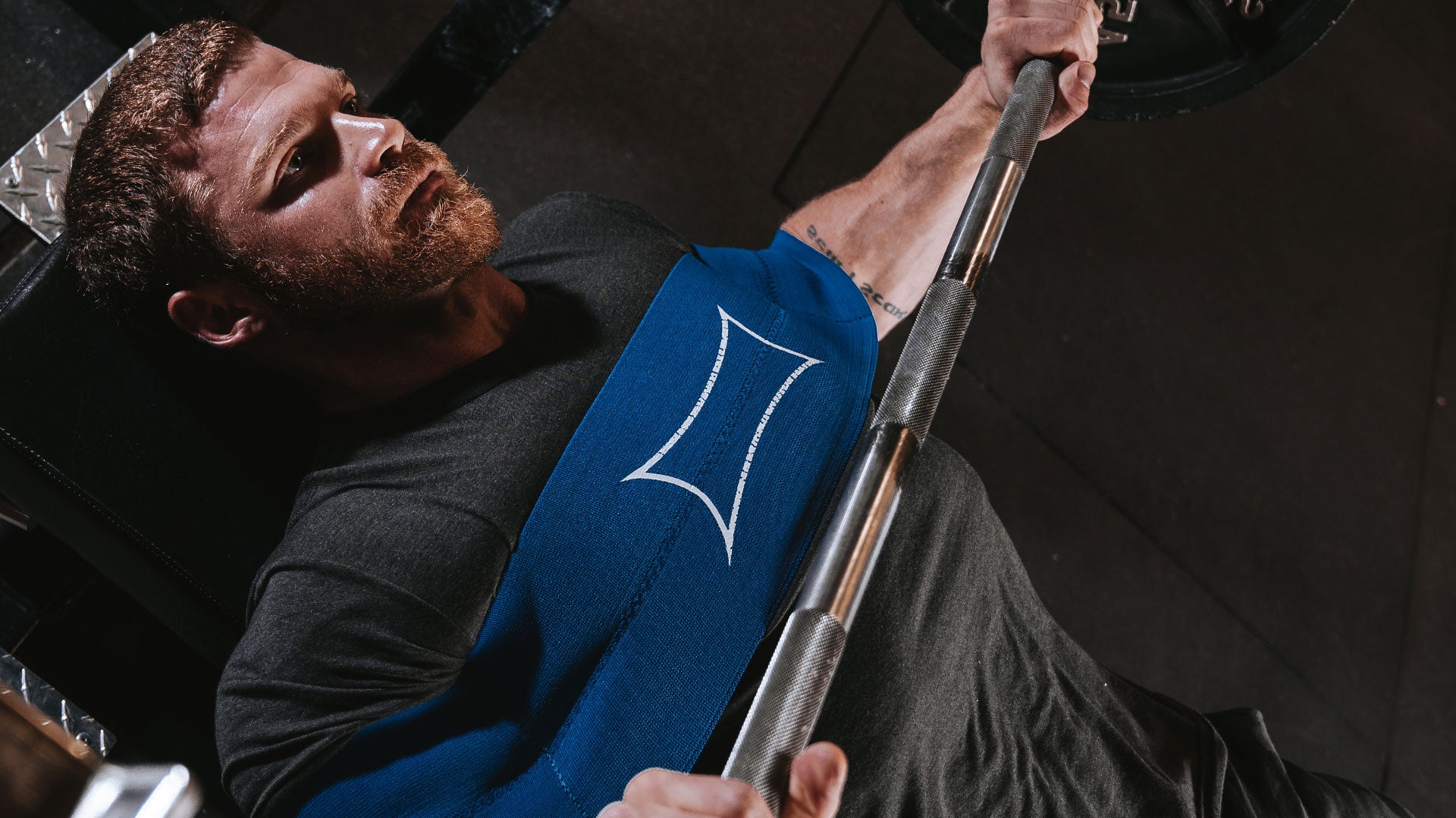 Male wearing blue sling shot while benching - Shop Sling Shot