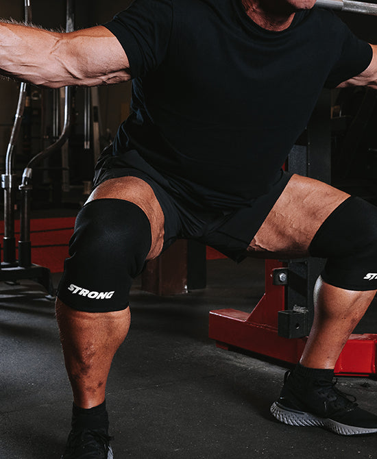 Male wearing knee sleeves while working out