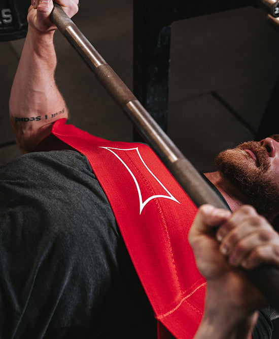 Male using sling shot during bench press